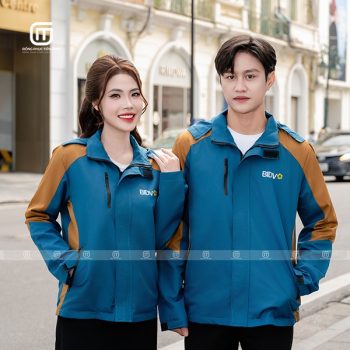 Đồng phục áo gió màu xanh cổ vịt và vàng bò